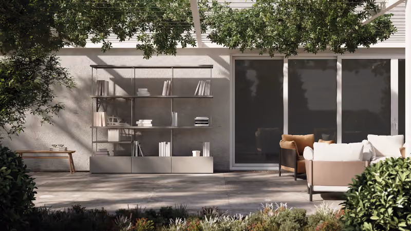 Outdoor living space with the Modularte Green Book outdoor bookcase, lounge armchairs and a flowering pergola on a designer terrace.